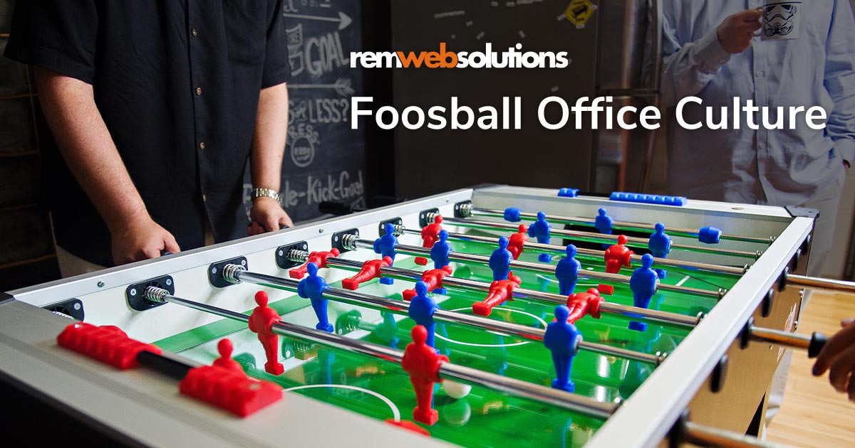 Todd playing foosball in the office